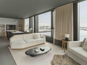 A dining area and seating area in a guest suite with floor-to-ceiling windows